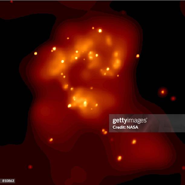 Bevy of black holes and neutron stars shine as bright, point-like sources against bubbles of million degree gas in this false-color x-ray image from...