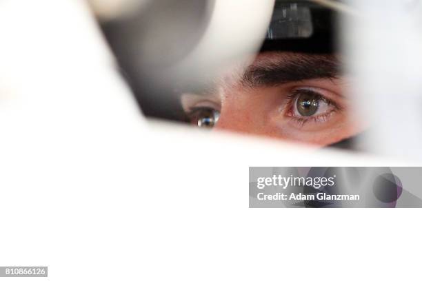 Ruben Garcia Jr., driver of the Max Siegel, Inc. Toyota, looks on from his car in the garage during practice before the NASCAR K&N Pro Series East at...