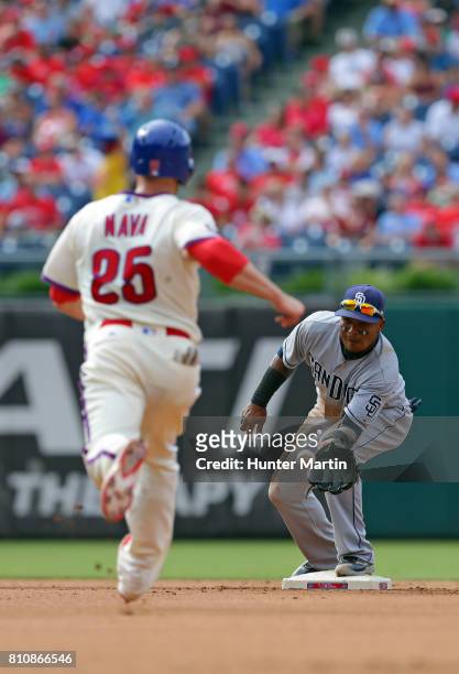 Daniel Nava of the Philadelphia Phillies is thrown out at second base as Erick Aybar of the San Diego Padres catches the throw in the fourth inning...