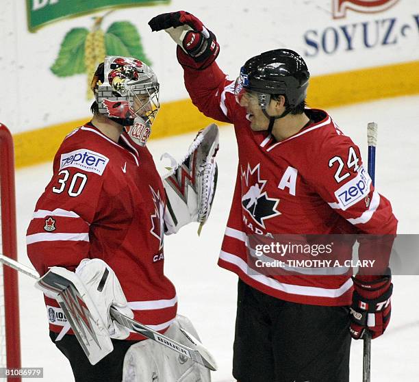 Canada's goalie Cam Ward and Steve Staios celebrate after defeating Norway in the quarterfinals of the 2008 IIHF World Hockey Championships at the...