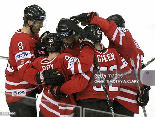 Canada's Derek Roy , who had a hat trick, is surrounded by teammates after his 2nd goal against Norway during the quarterfinals of the 2008 IIHF...