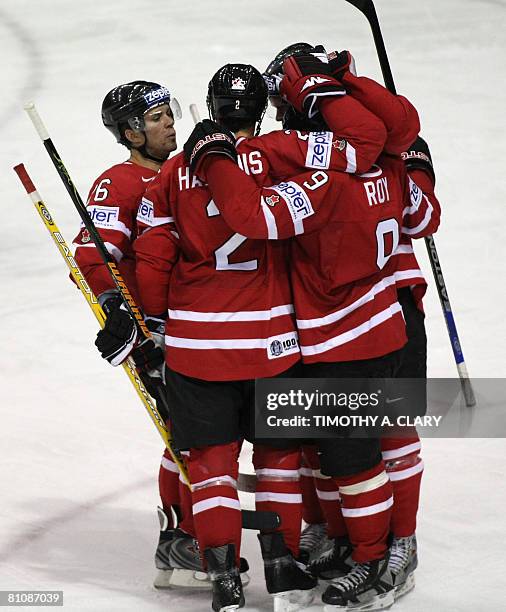 Canada's Derek Roy , who had a hat trick, is surrounded by teammates after his 3rd goal against Norway during the quarterfinals of the 2008 IIHF...