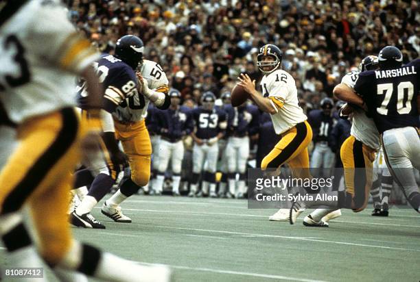 Hall of Fame quarterback Terry Bradshaw of the Pittsburgh Steelers looks for an open receiver during the Steelers 16-6 victory over the Minnesota...