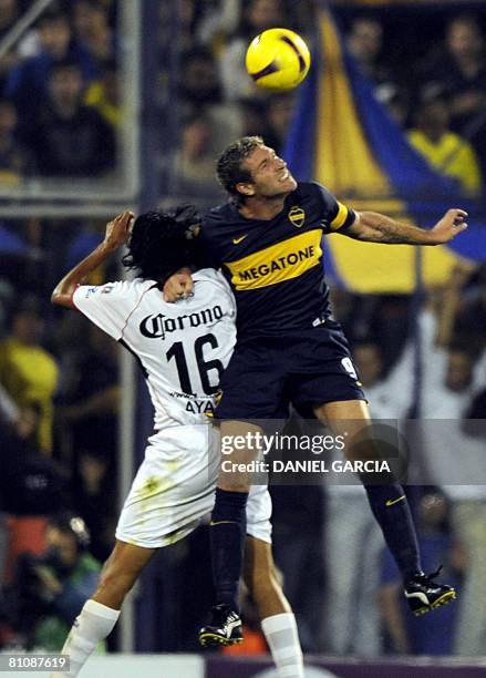 Argentina's Boca Juniors forward Martin Palermo vies for the ball with defender Hugo Ayala of Mexico's Atlas during the quarter finals football match...