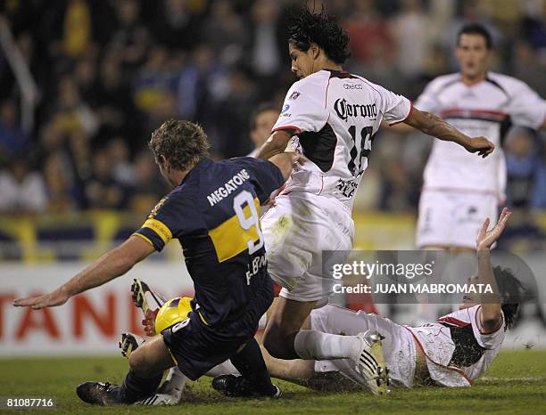 Mexico's Atlas defender Hugo Ayala scores an own goal next to Argentina's Boca Juniors forward Martin Palermo during their Libertadores Cup 2008...