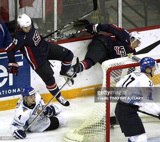 Finland's Ville Koistinen trips up USA's Dustin Brown during the quarterfinals of the 2008 IIHF World Hockey Championships at the Halifax Metro...