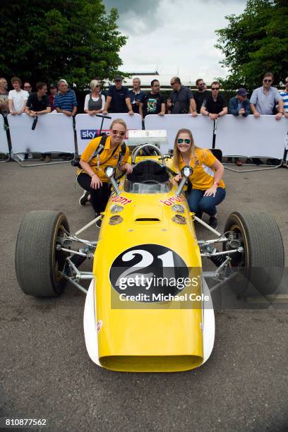 Meagan and Lauren McKinney pose beside Michael McKinney's 1967 Indy Race Car, the Vollstedt Ford Bryant Cooling in the Assembly Area during the...