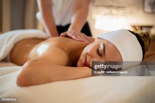 massage de la femme heureuse havng retour - masser photos et images de collection