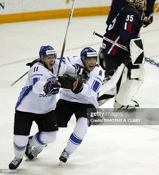 Finland's Saku Koivu and Teemu Selanne celebrate after the winning goal in overtime against the United States during the quarterfinals of the 2008...