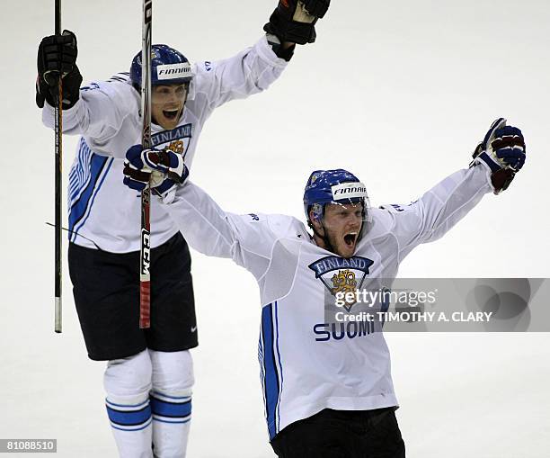 Finland's Saku Koivu and Teemu Selanne celebrate after the winning goal in overtime against the United States during the quarterfinals of the 2008...