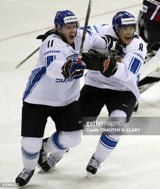 Finland's Saku Koivu and Teemu Selanne celebrate after the winning goal in overtime against the United States during the quarterfinals of the 2008...