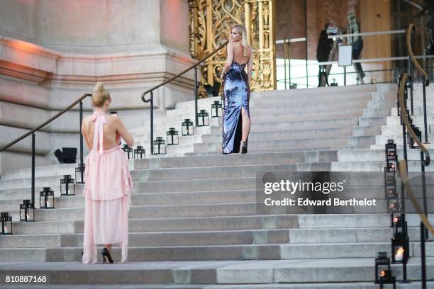 Guest takes a picture of another guest with her smartphone, outside the amfAR dinner at Petit Palais, during Paris Fashion Week - Haute Couture...