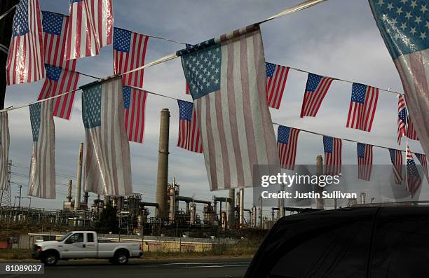 American flags fly at a used car lot across from the Shell refinery May 14, 2008 in Martinez, California. The national average for a gallon of...