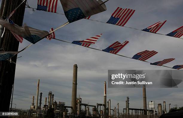 American flags fly at a used car lot across from the Shell refinery May 14, 2008 in Martinez, California. The national average for a gallon of...