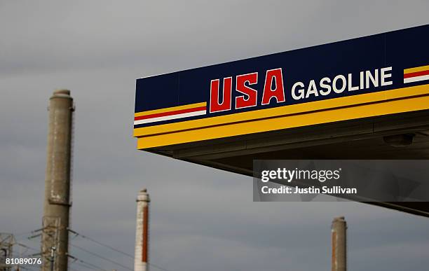 Gasoline gas station sign is seen in the shadow of smokestacks from a Shell refinery May 14, 2008 in Martinez, California. The national average for a...