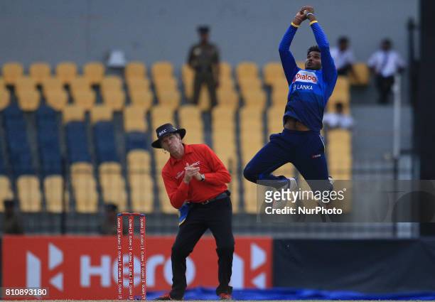Sri Lankan cricketer Wanindu Hasaranga takes a catch to dismiss Zimbabwe's Sikandar Raza(unseen during the 4th One Day International cricket matcth...