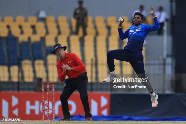 Sri Lankan cricketer Wanindu Hasaranga takes a catch to dismiss Zimbabwe's Sikandar Raza(unseen during the 4th One Day International cricket matcth...