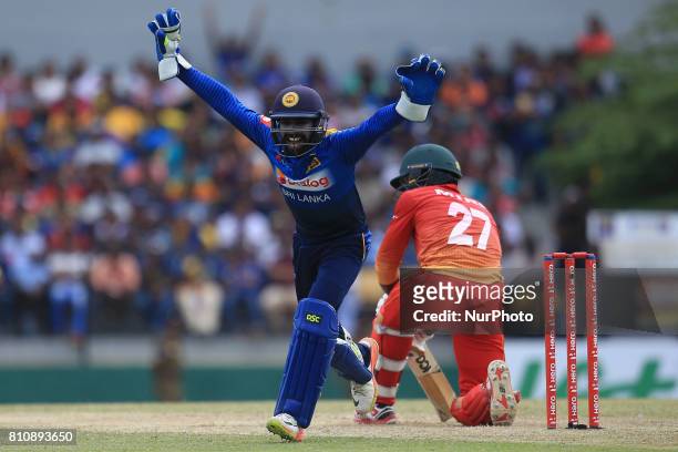 Zimbabwe cricketer Solomon Mire is dismissed as Sri Lanka's wicket keeper Niroshan Dickwella celebrates during the 4th One Day International cricket...