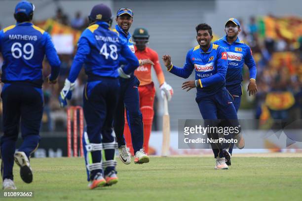 Sri Lanka's Wanidu Hasaranga celebrates with his team mates Sri Lankan/Zimbabwe cricketer during the 4th One Day International cricket matcth between...