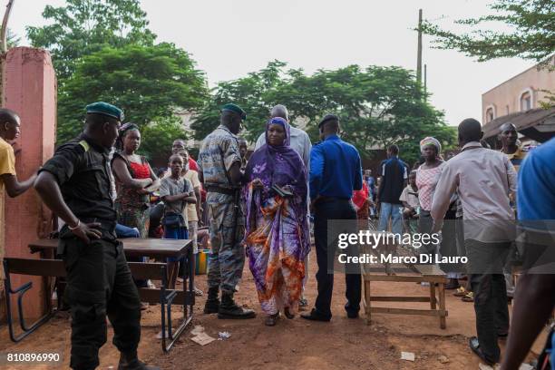 NMalian police officers check voters at the entrance of a pooling station during the first round of the Presidential election on July 28, 2013 in...