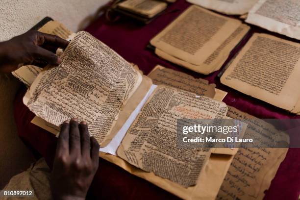 NMalian calligrapher Boubacar Sadeck, is seen at his house as he consults an ancient manuscript on July 29, 2013 in Bamako, Mali."nIn January 2012 a...