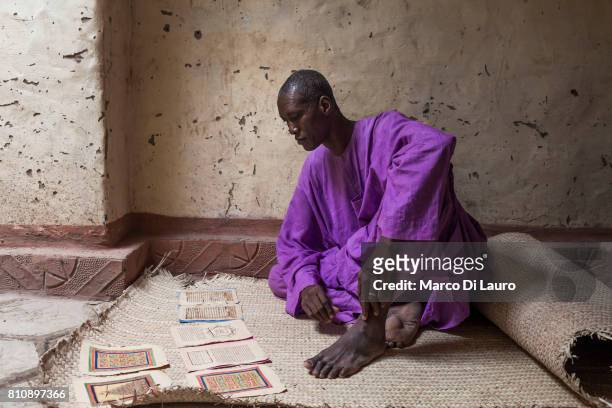 NMalian manuscript expert and librarian, Dramane Moulaye Haidara, 50-years-old is seen consulting an ancient manuscript at his house on August 10,...