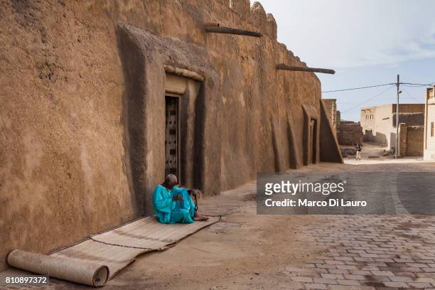 NA Malian man is seen sitting in front of the Djinguereber Mosque on August 10, 2013 in Timbuktu, Mali"nIn January 2012 a Tuareg rebellion began in...
