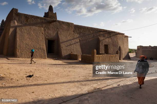 NA Malian woman passes by the Djinguereber Mosque on August 11, 2013 in Timbuktu, Mali"nIn January 2012 a Tuareg rebellion began in Northern Mali,...