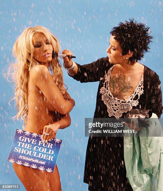 Fake snow falls as Kobe Kaige , current reigning Penthouse "Pet of the Year" has her make-up adjusted by Suzani Summer Rain as she poses for a...