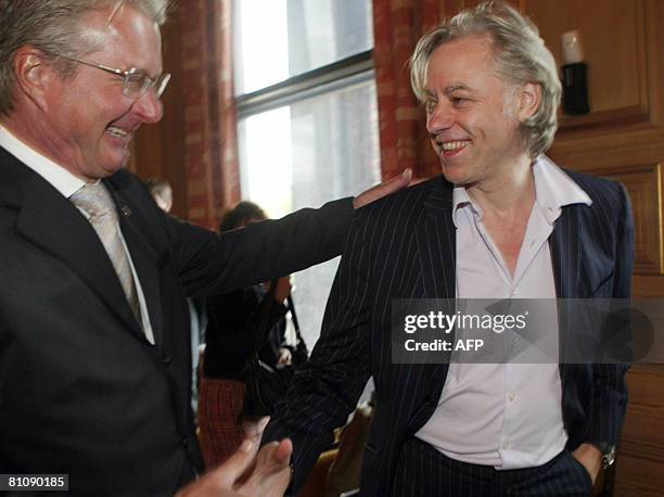 Bob Geldof shakes hands with Oslo Mayor Fabian Stang prior the opening of " The Oslo Conference on Peace and Trade" in Oslo City Hall, on May 15,...
