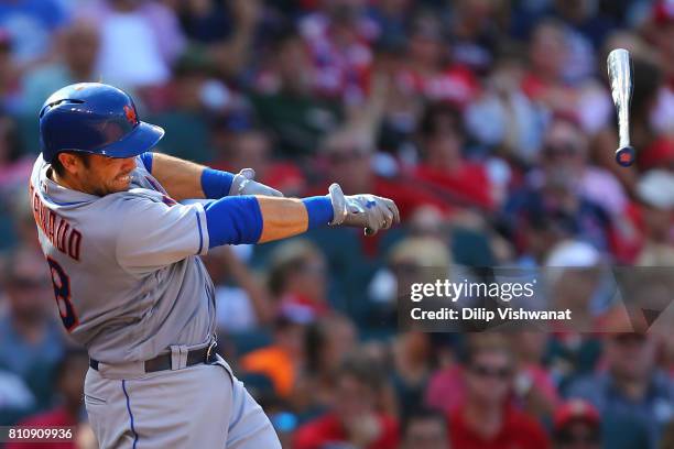 Travis d'Arnaud of the New York Mets looses his bat as he pops up into an out against the St. Louis Cardinals in the seventh inning at Busch Stadium...