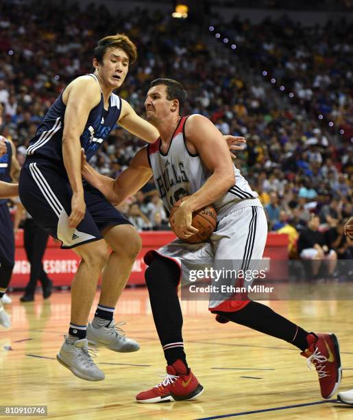 Paul Zipser of the Chicago Bulls drives against Ding Yanyuhang of the Dallas Mavericks during the 2017 Summer League at the Thomas & Mack Center on...