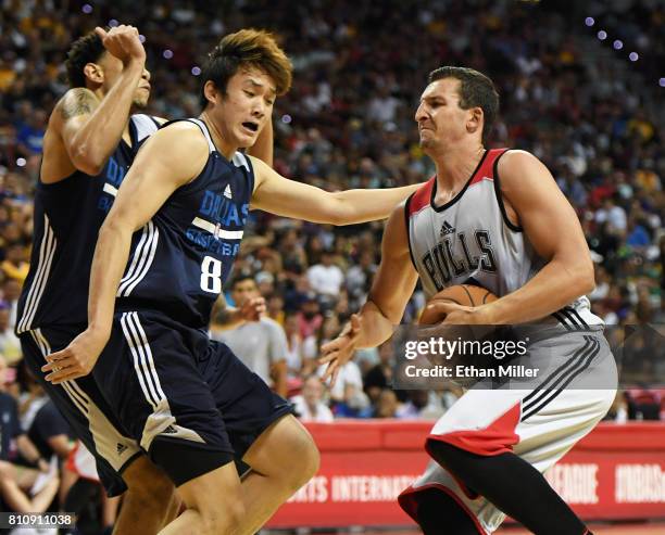 Paul Zipser of the Chicago Bulls drives against Ding Yanyuhang of the Dallas Mavericks during the 2017 Summer League at the Thomas & Mack Center on...