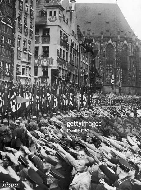 Nazi storm troops march through Nuremberg during the Party Congress, Germany, circa 1935.