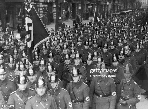 German police officers marching through Berlin to a mass meeting at the Lustgarten, where they and other organizations are to be addressed by...