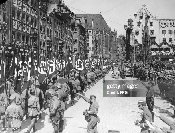 Nazi storm troops march past German Nazi leader Adolf Hitler at a parade in Nuremberg, Germany, during the Party Congress, 10th September 1934.