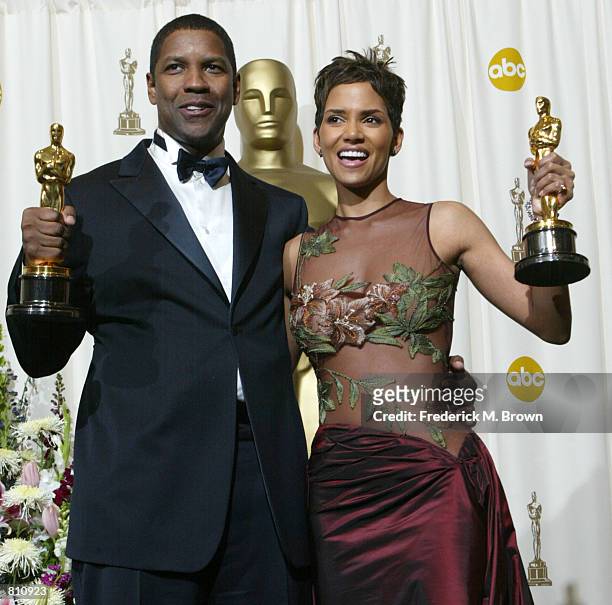 Best Actor and Actress winners Halle Berry and Denzel Washington pose with their Oscars backstage during the 74th Annual Academy Awards March 24,...