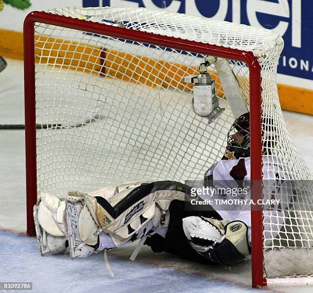 Latvia's goalie Edgars Masalskis gets knocked into the net during the qualification round of the 2008 IIHF World Hockey Championship against Germany...