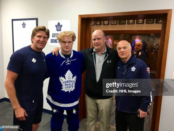 Toronto Maple Leafs Head Coach Mike Babcock, draftee Carl Grundstrom, Assistant General Manager Mark Hunter and General Manager Lou Lamoriello pose...