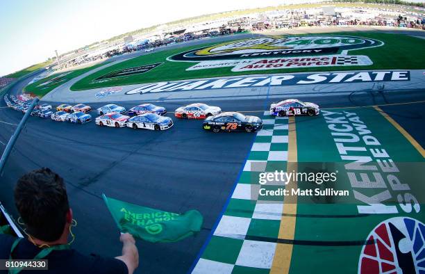 Kyle Busch, driver of the Snickers Toyota, leads Martin Truex Jr., driver of the Furniture Row/Denver Mattress Toyota and the rest of the field at...