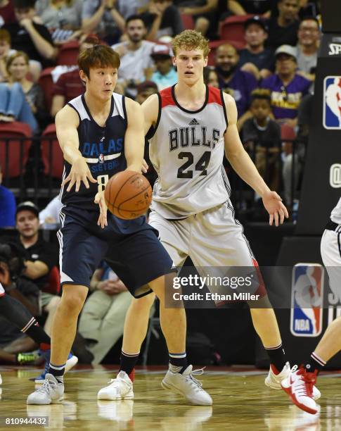 Ding Yanyuhang of the Dallas Mavericks passes against Lauri Markkanen of the Chicago Bulls during the 2017 Summer League at the Thomas & Mack Center...