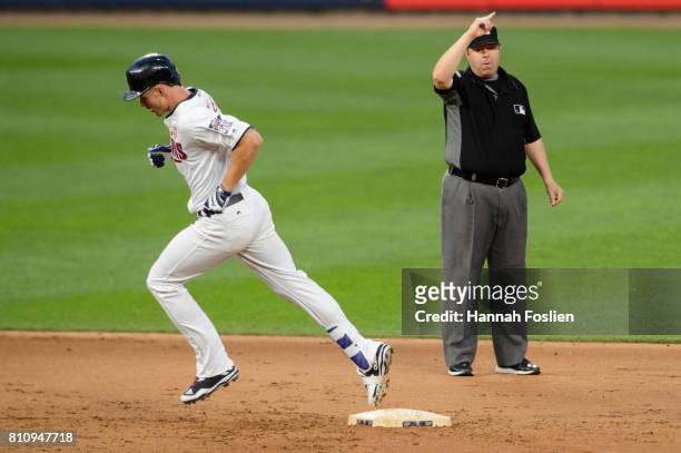 Umpire Doug Eddings signals a home run as Max Kepler of the Minnesota Twins runs the bases during the game against the Los Angeles Angels of Anaheim...