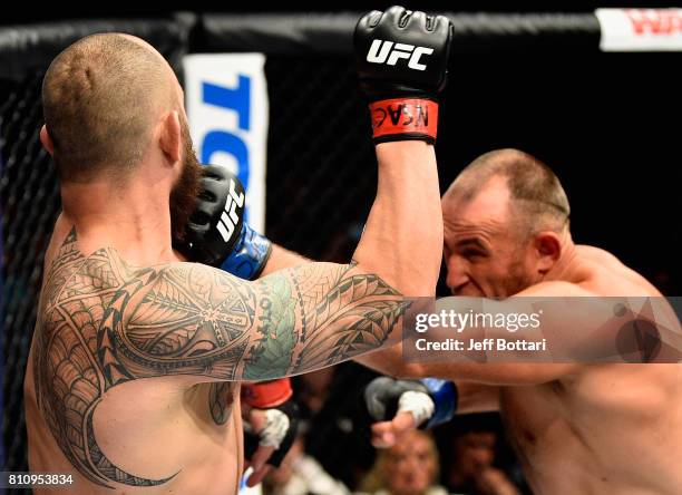 Aleksei Oleinik of Russia punches Travis Browne in their heavyweight bout during the UFC 213 event at T-Mobile Arena on July 8, 2017 in Las Vegas,...