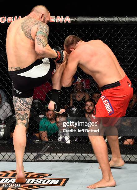 Travis Browne knees Aleksei Oleinik of Russia in their heavyweight bout during the UFC 213 event at T-Mobile Arena on July 8, 2017 in Las Vegas,...