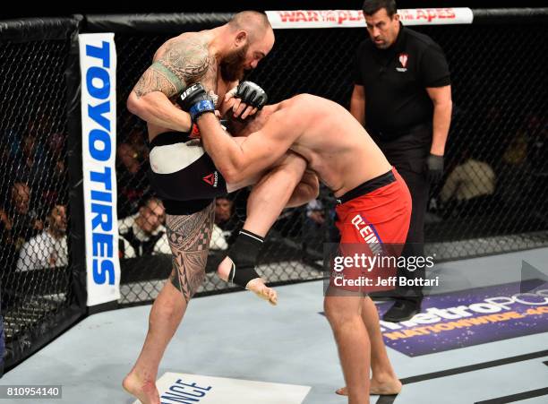 Travis Browne knees Aleksei Oleinik of Russia in their heavyweight bout during the UFC 213 event at T-Mobile Arena on July 8, 2017 in Las Vegas,...