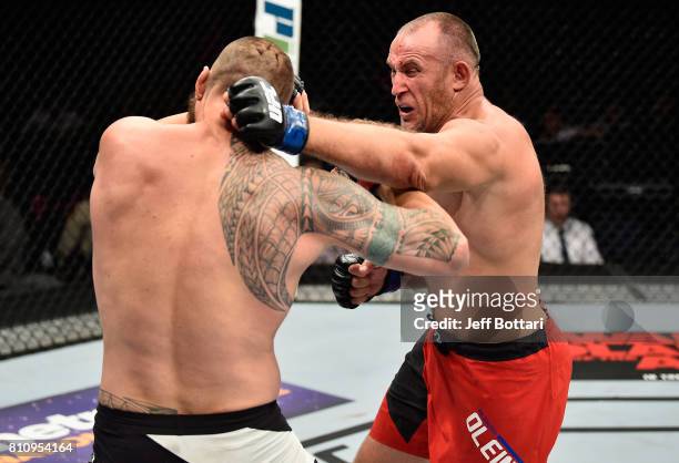 Aleksei Oleinik of Russia punches Travis Browne in their heavyweight bout during the UFC 213 event at T-Mobile Arena on July 8, 2017 in Las Vegas,...