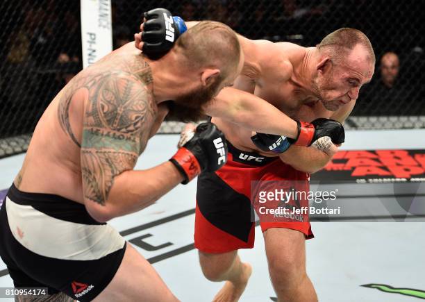 Travis Browne exchanges punches with Aleksei Oleinik of Russia in their heavyweight bout during the UFC 213 event at T-Mobile Arena on July 8, 2017...
