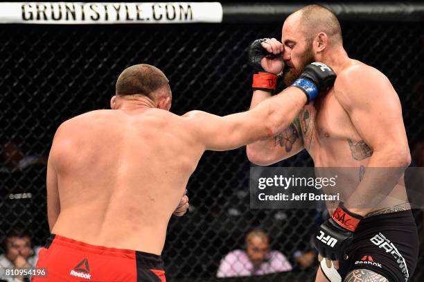 Aleksei Oleinik of Russia punches Travis Browne in their heavyweight bout during the UFC 213 event at T-Mobile Arena on July 8, 2017 in Las Vegas,...