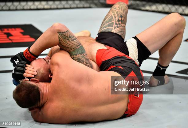 Aleksei Oleinik of Russia submits Travis Browne in their heavyweight bout during the UFC 213 event at T-Mobile Arena on July 8, 2017 in Las Vegas,...