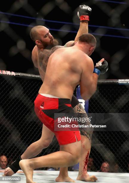 Travis Browne punches Aleksei Oleinik of Russia in their heavyweight bout during the UFC 213 event at T-Mobile Arena on July 8, 2017 in Las Vegas,...